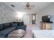 Spacious living room with a comfortable sofa, modern decor, and a ceiling fan at 1262 Stonewater Cir, Ocoee, FL 34761