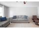 Bright living room featuring neutral tones and a comfortable gray sofa with decorative pillows at 1262 Stonewater Cir, Ocoee, FL 34761
