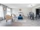 Open living space with a decorative fireplace, modern seating, and natural light from large windows at 1262 Stonewater Cir, Ocoee, FL 34761