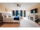 Spacious main bedroom with a ceiling fan, fireplace and large windows at 1262 Stonewater Cir, Ocoee, FL 34761