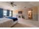 Bright main bedroom with a ceiling fan, fireplace and large windows at 1262 Stonewater Cir, Ocoee, FL 34761