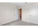 Bedroom features plush carpet, and white doors; one leading to a closet space at 150 Amberwood Way, Umatilla, FL 32784