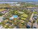 Overhead view of community features a sparkling pool, tennis courts, playground, and lush landscaping amid residences at 15527 Murcott Blossom Blvd, Winter Garden, FL 34787