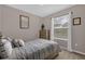 Comfortable bedroom featuring neutral tones and a sunlit window at 15527 Murcott Blossom Blvd, Winter Garden, FL 34787