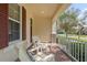 Comfortable front porch showcasing two Adirondack chairs with brick flooring at 15527 Murcott Blossom Blvd, Winter Garden, FL 34787