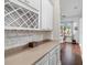 Butler's pantry featuring a wine rack, wine glass storage, and plenty of counter space at 1726 Astor Farms Pl, Sanford, FL 32771