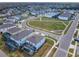 Aerial view of a community with homes, sidewalks, green spaces, and crisscrossing roadways at 178 Marcello Blvd, Kissimmee, FL 34746