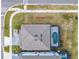 Aerial view of the roof, driveway, and pool with screened enclosure of a home near a corner lot at 178 Marcello Blvd, Kissimmee, FL 34746