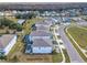 Aerial view of a community featuring homes with screened pools and well-maintained landscaping at 178 Marcello Blvd, Kissimmee, FL 34746