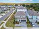 Overhead view of a two-story gray home in a suburban neighborhood with manicured lawns and tree-lined streets at 178 Marcello Blvd, Kissimmee, FL 34746