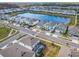 Aerial view of homes near a long lake with paved roads, sidewalks, and neighborhood landscaping at 178 Marcello Blvd, Kissimmee, FL 34746