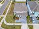 Aerial perspective of a house with well-maintained lawns, a paved driveway, and nearby community amenities at 178 Marcello Blvd, Kissimmee, FL 34746