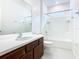 Bright bathroom features a white countertop, dark wood cabinets and a shower over tub at 178 Marcello Blvd, Kissimmee, FL 34746