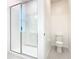 Modern bathroom features a glass-enclosed shower, white tile, and efficient toilet at 178 Marcello Blvd, Kissimmee, FL 34746