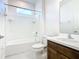 Bathroom features a white shower over tub with wood cabinets and white countertops at 178 Marcello Blvd, Kissimmee, FL 34746