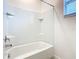 Bright bathroom featuring a tub/shower combination with white tiled walls at 178 Marcello Blvd, Kissimmee, FL 34746