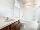 This bathroom offers a white shower over tub and dark wooden cabinets at 178 Marcello Blvd, Kissimmee, FL 34746