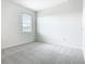 Bright, carpeted bedroom with a large window, and ample natural light at 178 Marcello Blvd, Kissimmee, FL 34746