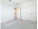 Neutral bedroom featuring carpet, white walls, and double doors leading to a closet at 178 Marcello Blvd, Kissimmee, FL 34746