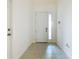 Inviting entryway with neutral walls, tiled floor and a front door with a vertical window panel bringing in lots of light at 178 Marcello Blvd, Kissimmee, FL 34746