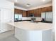 Spacious modern kitchen with large island, stainless steel appliances, custom cabinetry, quartz countertop, and tiled floors at 178 Marcello Blvd, Kissimmee, FL 34746