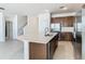 Open concept gourmet kitchen with a large island, stainless steel appliances, a kitchen sink, and barstool seating at 178 Marcello Blvd, Kissimmee, FL 34746