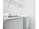 Laundry room showcases modern washer and dryer setup with overhead wire rack at 178 Marcello Blvd, Kissimmee, FL 34746