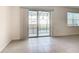 Spacious living area with a large sliding glass door leading to the pool area and tiled floors offering a seamless transition at 178 Marcello Blvd, Kissimmee, FL 34746