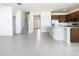 Open-concept living area with tiled flooring, view to stairs, and kitchen with stainless steel appliances at 178 Marcello Blvd, Kissimmee, FL 34746