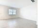 Bright living room with tiled floors, a large window with blinds, neutral paint, and ample space for entertaining at 178 Marcello Blvd, Kissimmee, FL 34746
