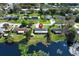 Aerial view shows home is on the lake and the surrounding area with a manicured lawn at 2006 Deborah Dr, Orlando, FL 32817