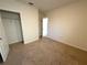 A bright bedroom features neutral carpet, a walk-in closet, and a light, neutral paint at 2877 Sunridge Loop, St Cloud, FL 34771