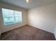 A carpeted bedroom features a window overlooking the front exterior of the home at 2877 Sunridge Loop, St Cloud, FL 34771