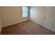 This carpeted bedroom offers a window and light, neutral walls at 2877 Sunridge Loop, St Cloud, FL 34771