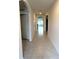 Hallway with arched entrances, neutral walls, and tile flooring at 2877 Sunridge Loop, St Cloud, FL 34771