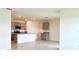 Modern kitchen with an island, gray cabinets, stainless steel appliances, and tile floors at 2877 Sunridge Loop, St Cloud, FL 34771