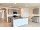 Modern kitchen with gray cabinets, granite countertops, and stainless steel appliances at 2877 Sunridge Loop, St Cloud, FL 34771