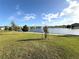 A community pond features a fountain and is surrounded by manicured lawns and shrubbery at 2877 Sunridge Loop, St Cloud, FL 34771