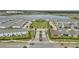 Aerial view of a neighborhood near a pond, with a green common and well-maintained landscaping at 2916 Satire St, Kissimmee, FL 34746