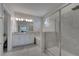Modern primary bathroom features a double vanity, a soaking tub, and a glass shower at 2916 Satire St, Kissimmee, FL 34746