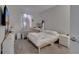 Bright bedroom features two beds, modern white furniture, soft gray carpet, and natural light at 2916 Satire St, Kissimmee, FL 34746