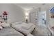 Well-lit bedroom showcases two beds, closet doors, a side table, and neutral walls at 2916 Satire St, Kissimmee, FL 34746