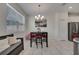 Bright dining area featuring a table and chairs set, plus a bench by the window at 2916 Satire St, Kissimmee, FL 34746