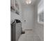 Bright entryway featuring neutral tile floors, a gray shoe cabinet, and a white front door at 2916 Satire St, Kissimmee, FL 34746