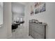 Bright entryway with neutral tile floors, gray cabinet, and view into spacious, open-concept living area at 2916 Satire St, Kissimmee, FL 34746