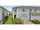 Charming two-story home with light blue siding, a one-car garage, and a well-manicured front yard at 2916 Satire St, Kissimmee, FL 34746