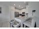 Bright kitchen featuring stainless steel appliances, white cabinets, and a quartz countertop island at 2916 Satire St, Kissimmee, FL 34746