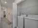 Convenient laundry closet including a modern washer and dryer, and shelving at 2916 Satire St, Kissimmee, FL 34746