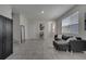 Spacious living room with tile flooring, comfortable gray sofa, and stairs to the second floor at 2916 Satire St, Kissimmee, FL 34746