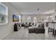 Spacious living room with tile flooring, two sofas, dining area, and view to the backyard at 2916 Satire St, Kissimmee, FL 34746